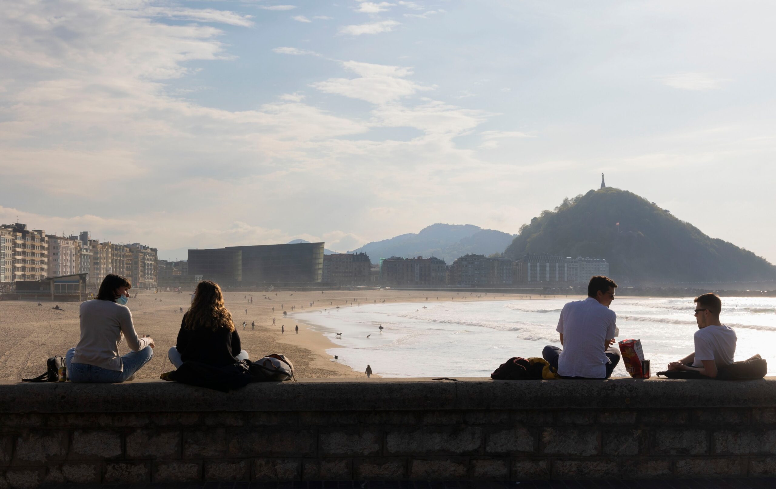 Locals hanging out for a sunset from Saqüés on the east side of Zurriola.